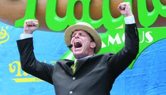 George Shea ’86 revs up the crowd at the 2010 Nathan’s hot dog eating contest. PHOTO: Matt Roberts